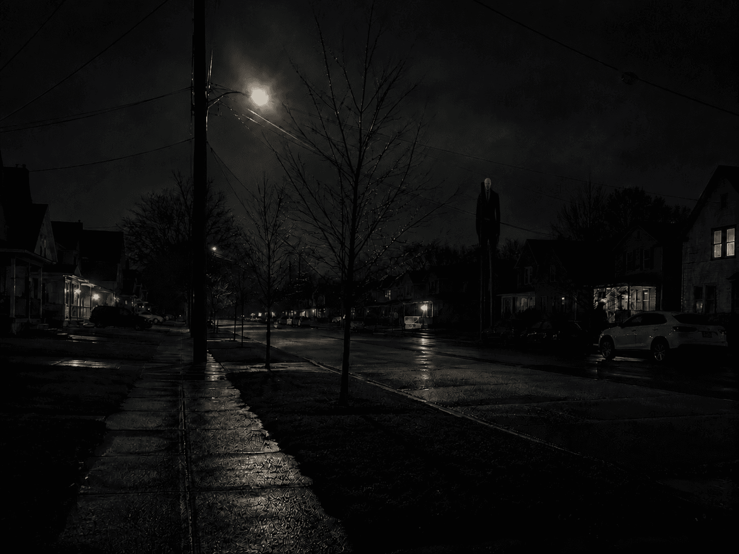 Tall dark figure looms over wet suburban street at night.
